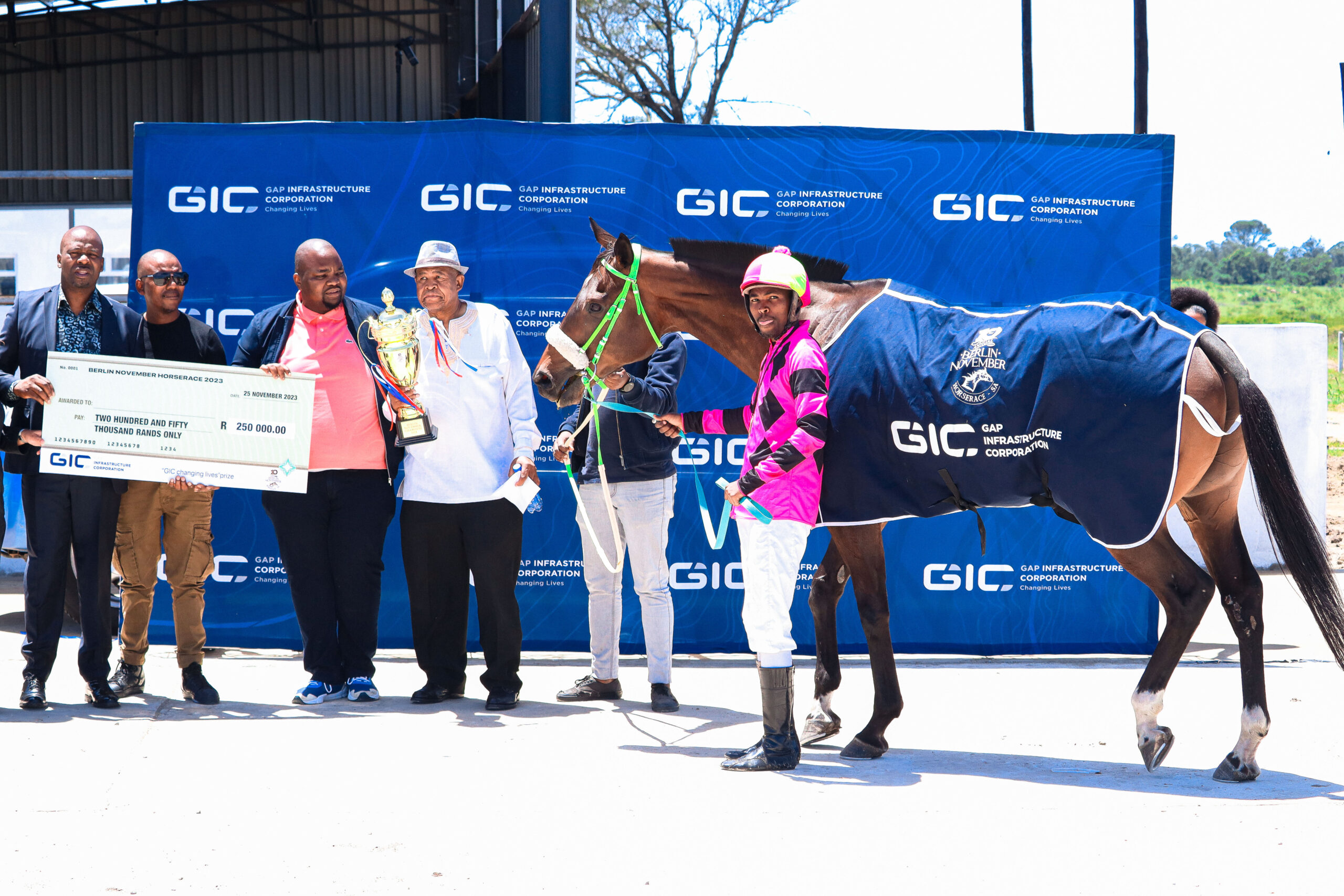 Wafa-Wafa champion Sandile Xoza, horse owner Lopez Magongo and the winning horse 'Konakelephi' being awarded the GIC Changing Lives prize money for winning the Berlin November 2023 race. Picture by Abuti-Photos